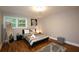 Cozy bedroom with wood floors, a queen bed, and bright natural light from the window at 2948 Legion Lake Rd, Douglasville, GA 30135