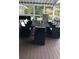 Outdoor deck area featuring an outdoor kitchen with a grill, seating, and a foosball table at 2948 Legion Lake Rd, Douglasville, GA 30135