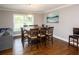 This dining area has hardwood floors, a large table, and stylish light fixture at 2948 Legion Lake Rd, Douglasville, GA 30135