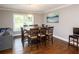 Dining room featuring a large wooden table with seating for eight and hardwood floors at 2948 Legion Lake Rd, Douglasville, GA 30135