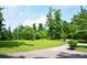 Scenic view of a home's entrance with a long driveway leading to a lush, green property at 2948 Legion Lake Rd, Douglasville, GA 30135