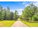 Long private driveway surrounded by lush greenery and mature trees at 2948 Legion Lake Rd, Douglasville, GA 30135