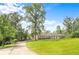 Ranch-style home with a well-manicured lawn, mature trees, and inviting driveway at 2948 Legion Lake Rd, Douglasville, GA 30135