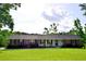 Charming one-story brick home with a well-manicured lawn, mature trees, and inviting curb appeal at 2948 Legion Lake Rd, Douglasville, GA 30135