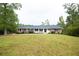 Well-maintained brick home with a spacious front yard and mature trees at 2948 Legion Lake Rd, Douglasville, GA 30135