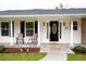Inviting front porch with rocking chairs, a welcome mat, and classic architectural details at 2948 Legion Lake Rd, Douglasville, GA 30135