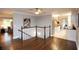 Open hallway featuring wood floors, staircase, and views into the living room and kitchen at 2948 Legion Lake Rd, Douglasville, GA 30135