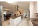Bright kitchen with white cabinetry, stainless steel appliances, and an island with a cooktop at 2948 Legion Lake Rd, Douglasville, GA 30135