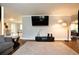 Cozy living room featuring hardwood floors, a mounted television, and modern lighting fixtures at 2948 Legion Lake Rd, Douglasville, GA 30135