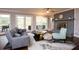 Cozy living room with fireplace, comfortable seating, and access to the outdoors through glass doors at 2948 Legion Lake Rd, Douglasville, GA 30135