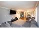 Large living room with gray sectional, hardwood floors, a TV, and neutral wall color at 2948 Legion Lake Rd, Douglasville, GA 30135