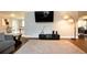 Well-lit living room with hardwood floors, a mounted television, and modern lighting fixtures at 2948 Legion Lake Rd, Douglasville, GA 30135