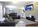 Comfortable living room with large sectional sofa, modern lighting, and entertainment center with a mounted TV at 2948 Legion Lake Rd, Douglasville, GA 30135
