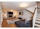 Cozy living room with a fireplace, plush seating, and wood floors at 2948 Legion Lake Rd, Douglasville, GA 30135