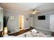 Bright main bedroom with ensuite bathroom, TV, ceiling fan and gray walls at 2948 Legion Lake Rd, Douglasville, GA 30135