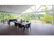 Large covered deck with a dining table, grill, and foosball table overlooking the lake at 2948 Legion Lake Rd, Douglasville, GA 30135