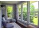 Serene sunroom with tranquil views through its large windows, offering a peaceful retreat at 2948 Legion Lake Rd, Douglasville, GA 30135
