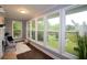 Bright sunroom featuring large windows, hardwood floors, and neutral decor with views of the outdoor greenery at 2948 Legion Lake Rd, Douglasville, GA 30135
