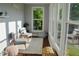 Bright sunroom offers natural light and calming seating area with a view of the backyard at 2948 Legion Lake Rd, Douglasville, GA 30135