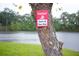 Caution sign near the waterfront emphasizing swim-at-your-own-risk near a beautiful lake at 2948 Legion Lake Rd, Douglasville, GA 30135