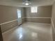 Finished basement area featuring neutral colored walls, a window, and tile flooring at 5790 Northspring Dr, Ellenwood, GA 30294