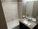 Bathroom featuring a vanity with a sink and mirror, complemented by a shower-tub combination at 5790 Northspring Dr, Ellenwood, GA 30294