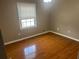 Bedroom with hardwood floors, a window and neutral colored walls at 5790 Northspring Dr, Ellenwood, GA 30294