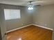 Bedroom featuring hardwood floors, a ceiling fan with lighting and a window for natural light at 5790 Northspring Dr, Ellenwood, GA 30294