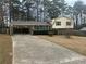 Charming home with a covered parking area and well-maintained front yard with mature landscaping at 5790 Northspring Dr, Ellenwood, GA 30294