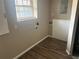 A laundry room with connections for a washer and dryer and a window at 5790 Northspring Dr, Ellenwood, GA 30294