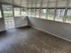 Bright sunroom features multiple windows, neutral walls, and wood flooring at 5790 Northspring Dr, Ellenwood, GA 30294