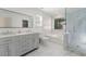 A beautifully renovated bathroom includes double vanity sinks, a soaking tub, and a separate glass shower at 1183 Lanier Springs Dr, Buford, GA 30518