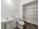 Efficient powder room includes modern fixtures, a pedestal sink, and a convenient storage closet at 1183 Lanier Springs Dr, Buford, GA 30518