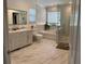 A beautifully renovated bathroom includes double vanity sinks, a soaking tub, and a separate glass shower at 1183 Lanier Springs Dr, Buford, GA 30518