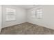 This bedroom has neutral carpet, two windows and fresh, white paint at 1183 Lanier Springs Dr, Buford, GA 30518