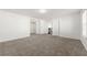 A spacious bedroom with plush carpeting, bright white walls, and access to other rooms in the house at 1183 Lanier Springs Dr, Buford, GA 30518