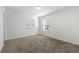 Bright bedroom with windows, plush carpeting, and neutral walls providing a perfect canvas to create your own haven at 1183 Lanier Springs Dr, Buford, GA 30518