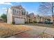 Charming two-story home with a two-car garage, stone accents, and manicured lawn in a Gathering-friendly neighborhood at 1183 Lanier Springs Dr, Buford, GA 30518