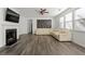Spacious living room with a fireplace, a white leather sectional sofa, and hardwood floors at 1183 Lanier Springs Dr, Buford, GA 30518
