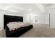 A spacious main bedroom showcases a luxurious bed frame and plush carpeting at 1183 Lanier Springs Dr, Buford, GA 30518