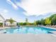 Beautiful community pool with clear blue water, lounge chairs, and clubhouse amenities under a sunny sky at 1735 Fulmont Cir, Mableton, GA 30126