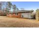 Expansive backyard view featuring a mix of lawn and trees along the side of the home at 1893 Kenwood Se Rd, Smyrna, GA 30082