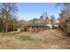 Wide view of a large backyard behind a brick and siding home with mature trees nearby at 1893 Kenwood Se Rd, Smyrna, GA 30082