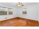 Sunny bedroom featuring wood floors and multiple windows at 1893 Kenwood Se Rd, Smyrna, GA 30082
