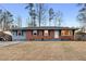 Charming single-story brick home with a manicured front lawn and a convenient carport at 1893 Kenwood Se Rd, Smyrna, GA 30082