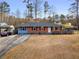 Inviting one-story home with blue and red brick exterior, front yard, and a long driveway at 1893 Kenwood Se Rd, Smyrna, GA 30082