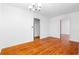 Spacious living room with beautiful hardwood floors and a classic chandelier at 1893 Kenwood Se Rd, Smyrna, GA 30082