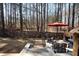 Charming backyard with stone steps, a cozy seating area under a red umbrella, and a privacy fence at 1055 Amarose Ne Ln, Marietta, GA 30066