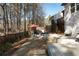 Expansive backyard boasts a stone patio, comfortable seating, a wooden fence, and a backdrop of mature trees at 1055 Amarose Ne Ln, Marietta, GA 30066