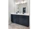 Elegant bathroom featuring a double vanity with modern fixtures and a sleek mirror at 1055 Amarose Ne Ln, Marietta, GA 30066